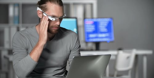 Young Adult Using Laptop in Office