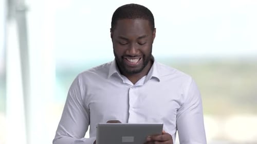 Attractive Dark-skinned Businessman Using Pc Tablet