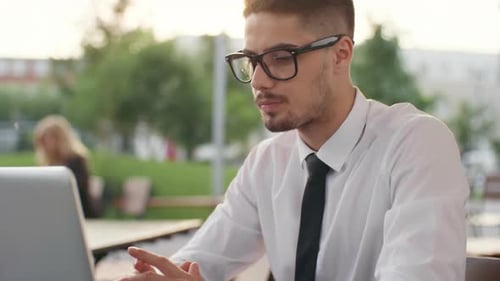 Young Adult Using Laptop Outdoors