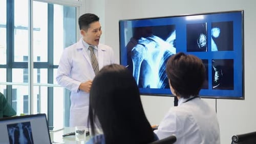Doctors Analyzing X-Rays During Medical Meeting