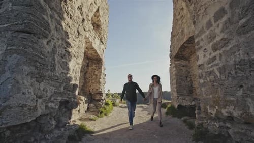 Two Tourists Discover the Medieval Castle on a Green Hill, While Hiking on a Sunny, Summer Day.