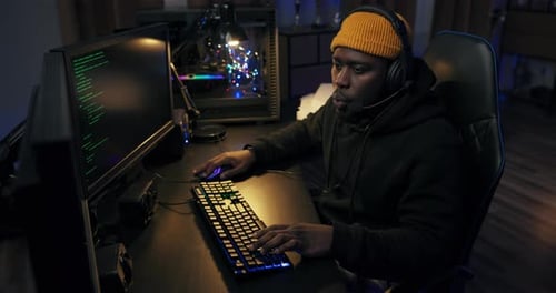 Man Works at Computer Gaming Online