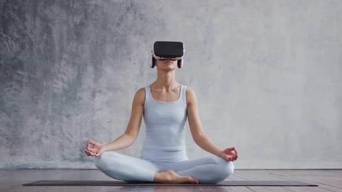 Woman Meditating in VR Headset on Yoga Mat