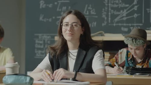 Portrait of Female Student at Desk in High School