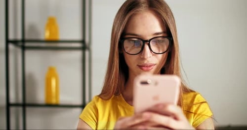 Young Woman Using Smartphone Indoors, Close Up