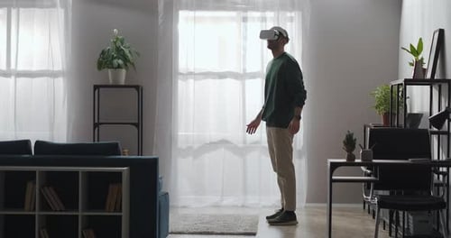 Man Experiencing Virtual Reality in Modern Living Room