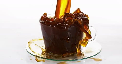 900153 Coffee beans Falling in a Cup against White Background, Slow motion