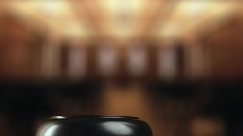 Judge is Hitting Gavel Off a Block in Courtroom