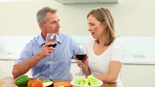 Happy Couple Drinking Wine in Bright Kitchen