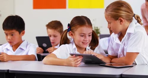 Students using digital tablet in classroom