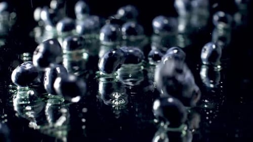 Blueberries Falling in Slow Motion with Water Droplets