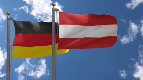 German and Austrian Flags Waving in Wind on Flagpoles