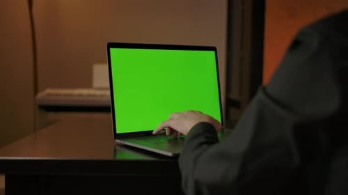 Man Typing on Laptop Keyboard with Green Screen Dolly Out Smooth Sliding Shot