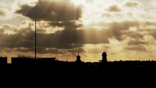 Sunlight Rays Shine Through Clouds at Dusk