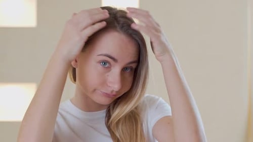 Sad Girl Looking at Her Damaged Hair
