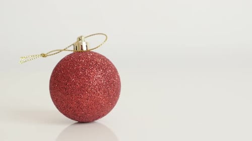 Decorative red bauble with sequins close-up 4K 2160p 30fps UltraHD tilting footage - Shiny Christm