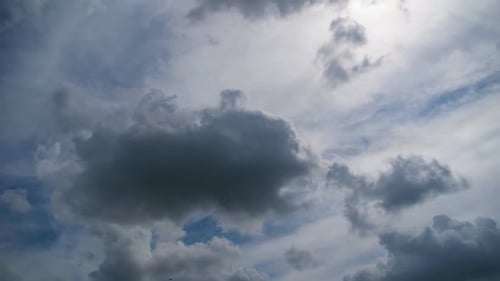 Fluffy White Clouds Against a Blue Sky