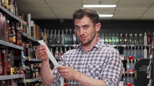Man Looks Devastated After Paying Shopping Bill at the Supermarket