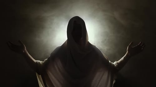 Silhouette of Figure Raising Arms in Smoke and Darkness