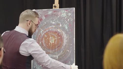 Auction Worker Placing Modern Painting on Easel