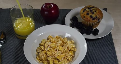 Inviting Breakfast Spread with Cornflakes and Orange Juice