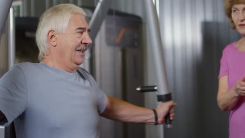 Old Man Exercising in Gym