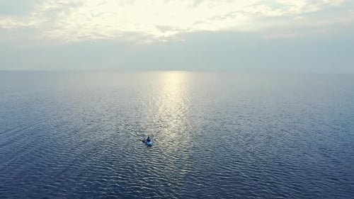 Sportsman Swimming Kayak in Sea at Sunset