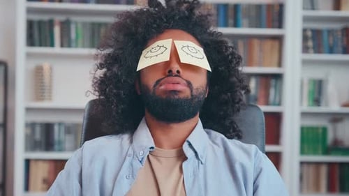 Tired Young Arabian Man Sleeps Working with Paper Stickers in Front of Eyes