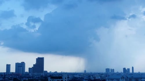 Timelapse of a Rain Cloud forming over a city with buildings