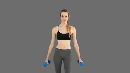 Woman Lifting Weights in Fitness Studio