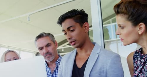 Team Collaborating on Computer in Office Setting