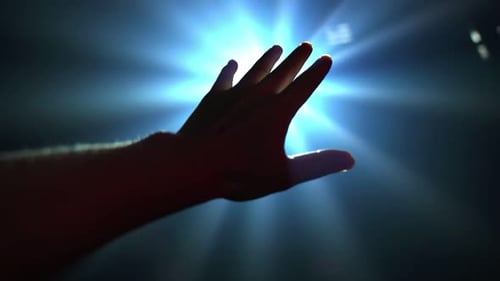 Hand Reaching for Light in the Darkness
