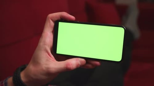 Close Up Man Hands Holding Chromakey Green Screen Smartphone Watching Content Swiping Scrolling on