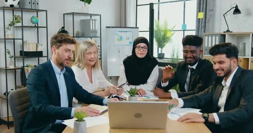 Smiling Colleagues in Video Conference at Workplace