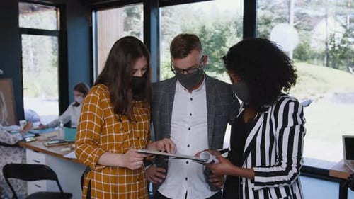 Group Analyzes Documents in Modern Office Setting