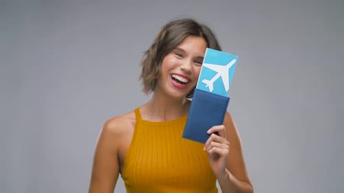 Happy Young Woman with Air Ticket and Passport