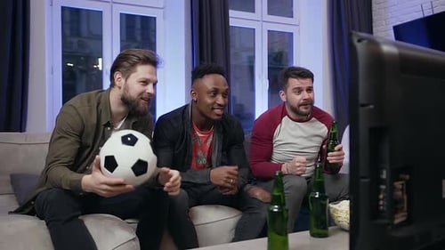 Excited Friends Cheering at Home Watching Soccer on TV
