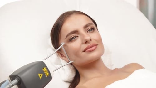 Beautician Holding Neodymium Laser Near Woman Face