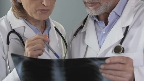 Doctors Reviewing X-Ray in Medical Office