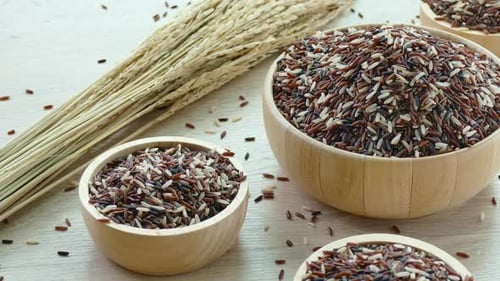 Raw Multi-Colored Rice Grains in Wooden Bowls