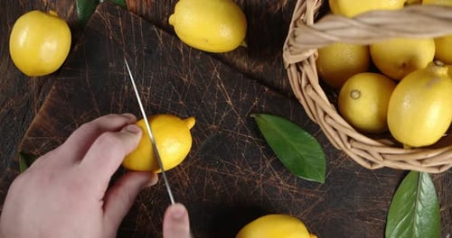 Cutting Yellow Lemon on a Cutting Board