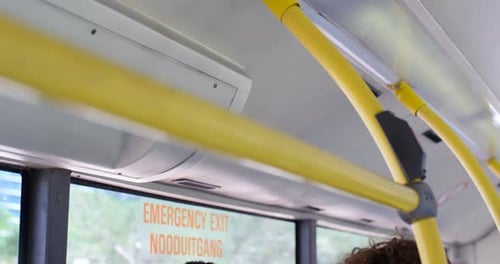 Smiling Young Adults Using Tablet on a Bus