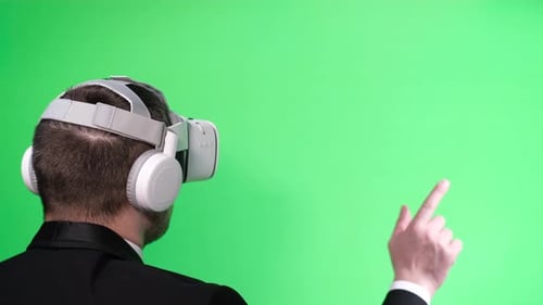 Business Worker Uses Virtual Reality Glasses on the Background of a Chromakey