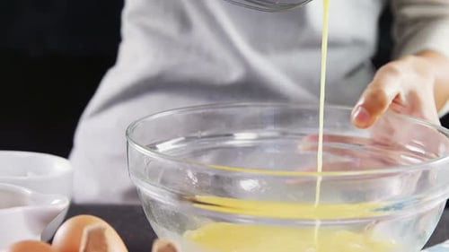 Whisking Yellow Batter in Glass Bowl for Baking