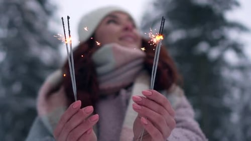 Close-up of Female Hands Holding Burning Sparklers