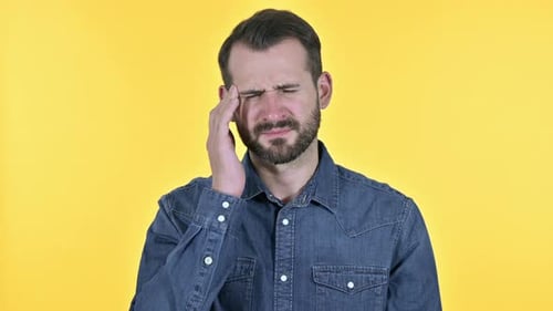 Tired Beard Young Man Having Headache, Yellow Background
