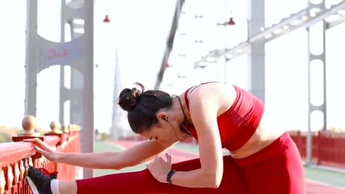 Young Woman Stretching Legs on Urban Bridge