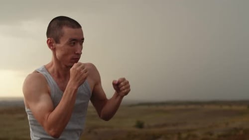Man Boxing on Hilltop Outdoors
