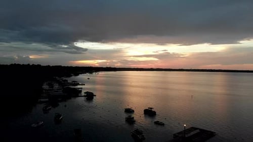 drone sunset shot silhouetted boats on lake