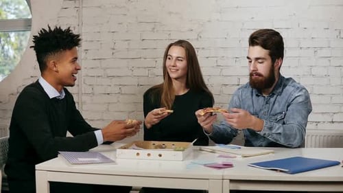 Business Team of Young People Enjoying Pizza Together in the Office Millennials Group Talking Having
